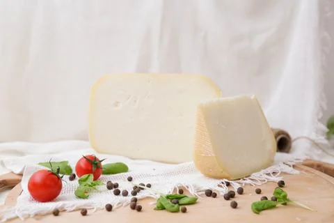 Medium hard cheese head parmesan on wooden board, with cheese parmesan with t 写真素材