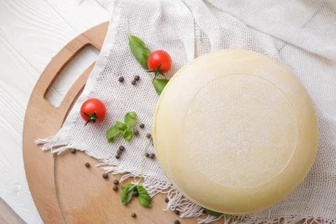Medium hard cheese head parmesan on wooden board, with cheese parmesan with t Stock Photos