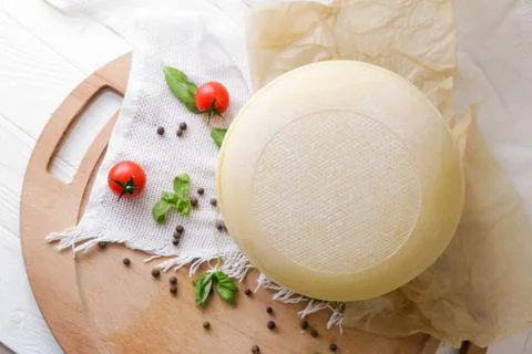 Medium hard cheese head parmesan on wooden board, with cheese parmesan with t 写真素材