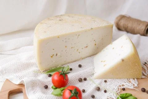 Medium hard cheese head parmesan on wooden board, with cheese parmesan with t 写真素材