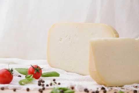 Medium hard cheese head parmesan on wooden board, with cheese parmesan with t 写真素材