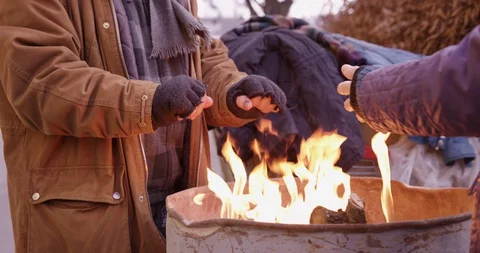 Medium Of Homeless Couple Warming Up Their Hands Stock Footage 128774135