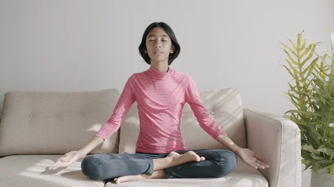 Medium long shot. Asian girl Practicing yoga In the prayer position Stock Footage 128742853