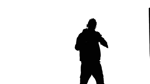 Medium long shot of guy dancing hip hop, freestyle, street dance, silhouette Stock Footage 130319502