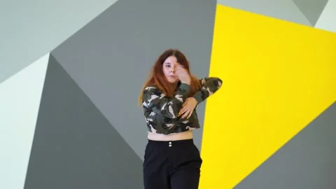 Medium long shot of young energetic woman dancing hip hop in a dance studio. Stock Footage 142820394