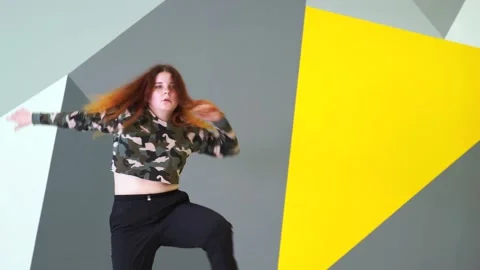 Medium long shot of young energetic woman dancing hip hop in a dance studio. Stock Footage 142820401