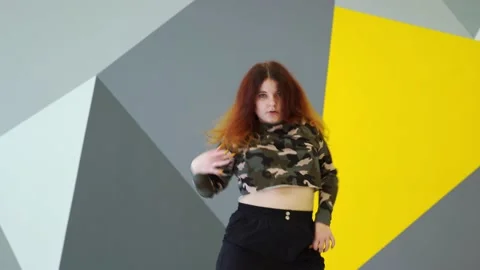 Medium long shot of young energetic woman dancing hip hop in a dance studio. Stock Footage 142820409