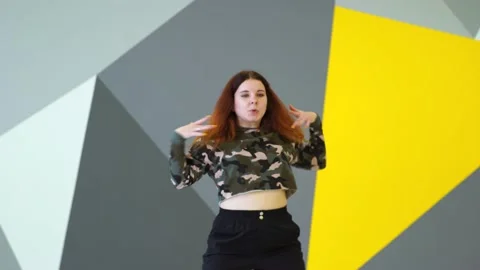 Medium long shot of young energetic woman dancing hip hop in a dance studio. Stock Footage 142820447