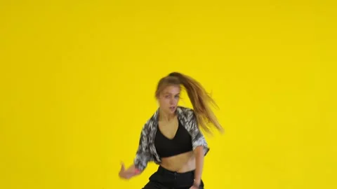 Medium long shot of young energetic woman dancing hip hop. Isolated Stock Footage 142820672