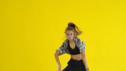Medium long shot of young energetic woman dancing hip hop. Isolated Stock Footage 142820686