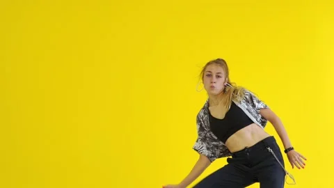 Medium long shot of young energetic woman dancing hip hop. Isolated Stock Footage 142820688