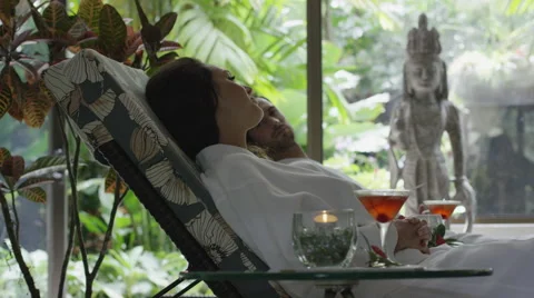 Medium low angle panning shot of couple relaxing in spa / Arenal, La Fortuna, Stock Footage 48510741