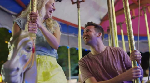 Medium low angle shot of couple kissing on carousel / Pleasant Grove, Utah, Vídeo Stock 68217963