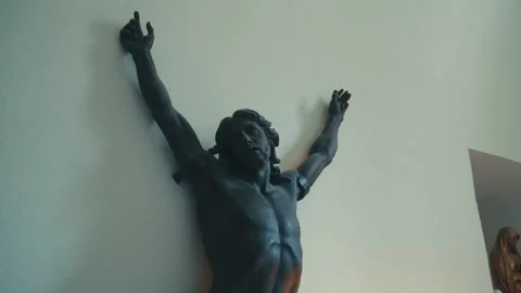 Medium Low-Angle Shot of a Dark Bronze Statue of Jesus Christ Mounted on a Stock Footage 340066568