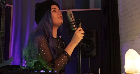 Medium-low angle shot of EDM house music female pretty singer rehearsing live Video stock 158873044