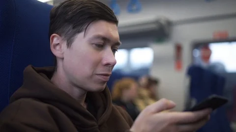 Medium low angle shot of man using cell phone on subway / New York, New York Video stock 101984223