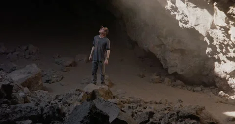 Medium of man standing on caved in rock inside of cavern Stock Footage 220910344