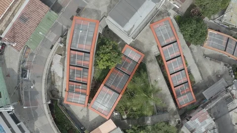 Medium overhead aerial progresses over the orange escalators of Comuna 13 Stock-Footage 105621197