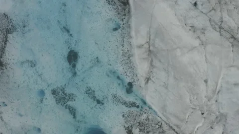 Medium overhead aerial strafes over vibrant blue lake on Knik glacier in Alaska Vídeos de archivo 159255690