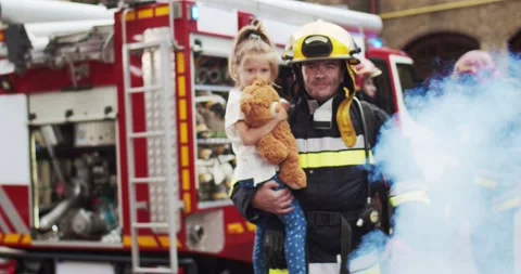 Medium plan of firefighter approaches from fire van with flashing lights on with Stock Footage 137895522