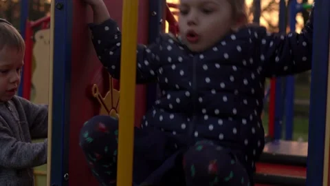 Medium plan Portrait of one cute little Siblng girl having fun playing outside Stock Footage 172552620