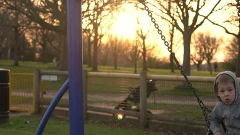 Medium plan Portrait of Two cute little Siblngs having fun Swinging On Swing Stock Footage 172507910