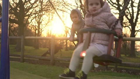 Medium plan Portrait of Two cute little Siblngs having fun Swinging On Swing Stock Footage 172507932