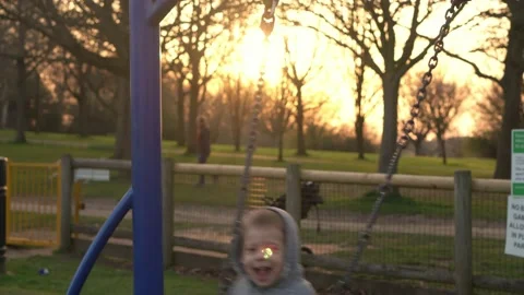Medium plan Portrait of Two cute little Siblngs having fun Swinging On Swing Stock Footage 172756855