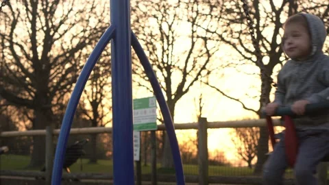 Medium plan Portrait of Two cute little Siblngs having fun Swinging On Swing Stock Footage 172757686
