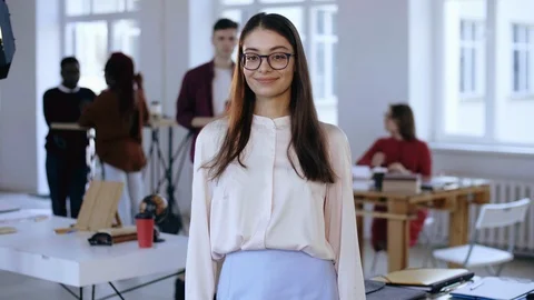 Medium portrait of beautiful young smart brunette business woman in eyeglasses Stock Footage 107979757