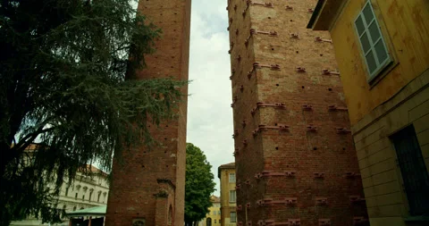 Medium Position POV Tilt Up of Two Medieval Watchtowers in Pavia, Italy Stock Footage 203754607