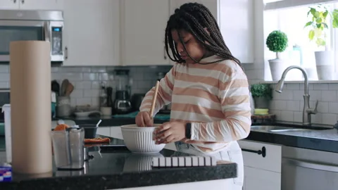 Medium profile view of African American teenage girl mixing bread dough Video stock 194465982