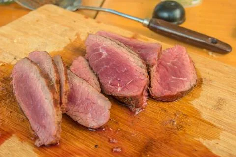 Medium rare angus beef steak cutted on wooden board. Stock Photos