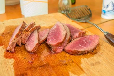Medium rare angus beef steak cutted on wooden board. Stock Photos