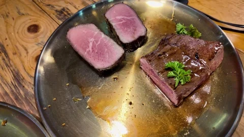 Medium Rare Grilled Beef Steak Served on Metal Plate in Cinematic Food Style Stock Footage 335206171
