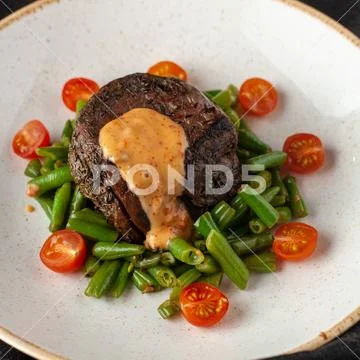 Medium rare mignon fillet roasted with green beans and fresh cherry tomatoes, Stock Photos