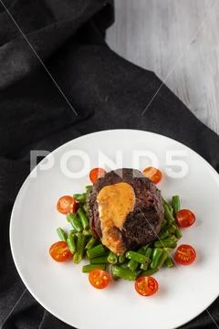Medium rare mignon fillet roasted with green beans and fresh cherry tomatoes, Stock Photos