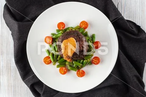 Medium rare mignon fillet roasted with green beans and fresh cherry tomatoes, Stock Photos