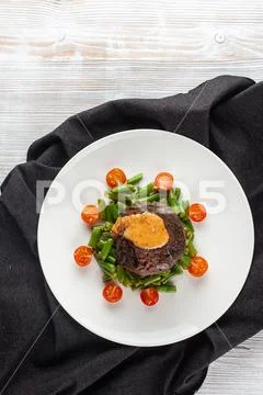 Medium rare mignon fillet roasted with green beans and fresh cherry tomatoes, Stock Photos