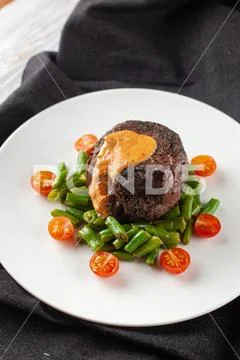 Medium rare mignon fillet roasted with green beans and fresh cherry tomatoes, Stock Photos