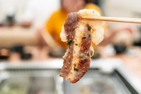 A medium rare slice of A5 Saga Wagyu with high marble texture. Stock Photos
