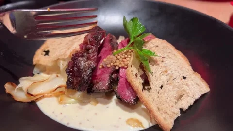 Medium rare steak BBQ in the garden. Salt falls on the filet mignon resting on Stock Footage 303487356