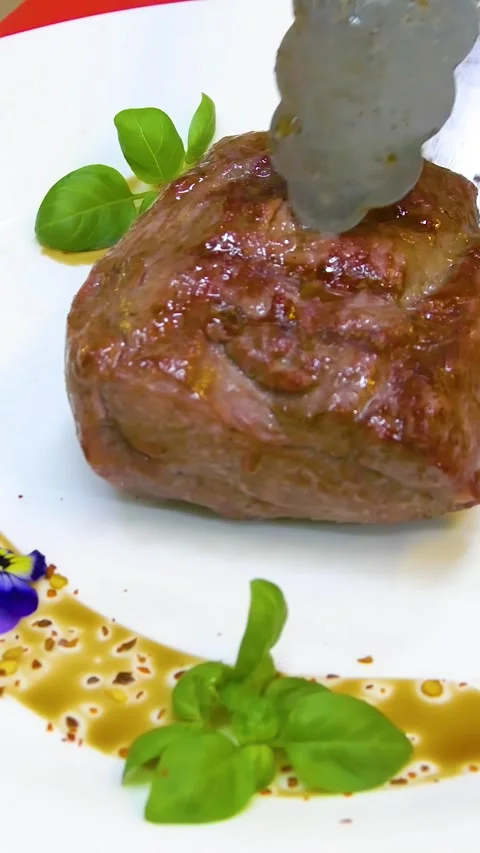 Medium rare steak, beautifully served on a white plate. Vertical video. Stock Footage 290217274