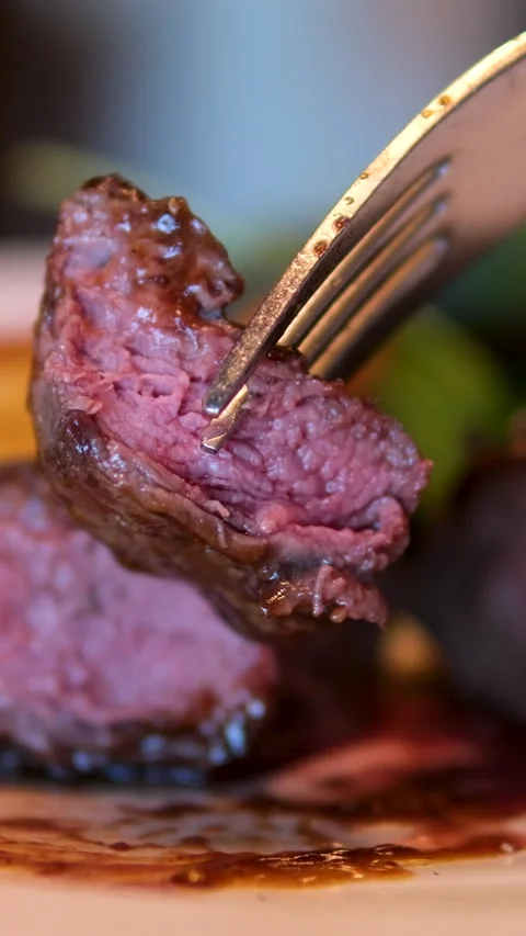 Medium rare steak plate with roasted tomato, garlic, and fresh herbs Stock Footage 296076184
