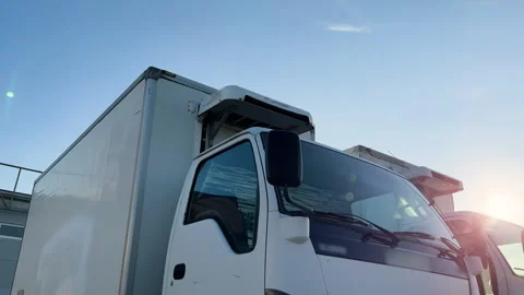 Medium refrigerated or reefer trucks wait at the truck stop for unload and load Stock Footage 253614464