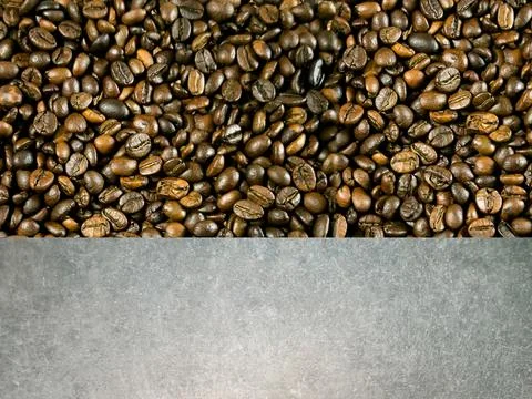 Medium roast coffee beans (Full City or American ), and gray cement floor Stock-Fotos
