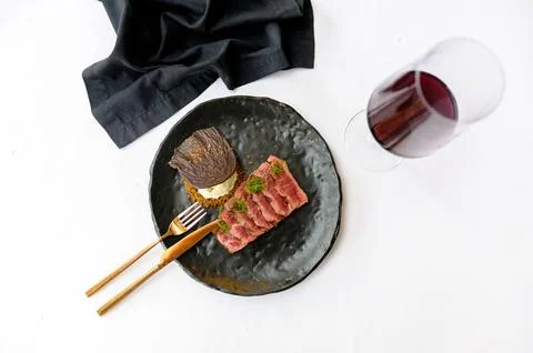 Medium roasted beef slices on a black plate Stock Photos
