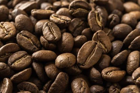Medium roasted coffee beans background. Macro texture of organic coffee grain Stock Photos