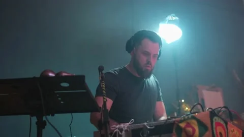 Medium sho low anglet of a dj musician plays music on a party Stock Footage 233524875
