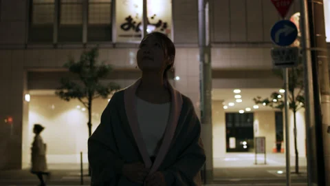 Medium shot on 4k RED camera. Beautiful, cheerful Japanese woman walking down a Stock Footage 199462094